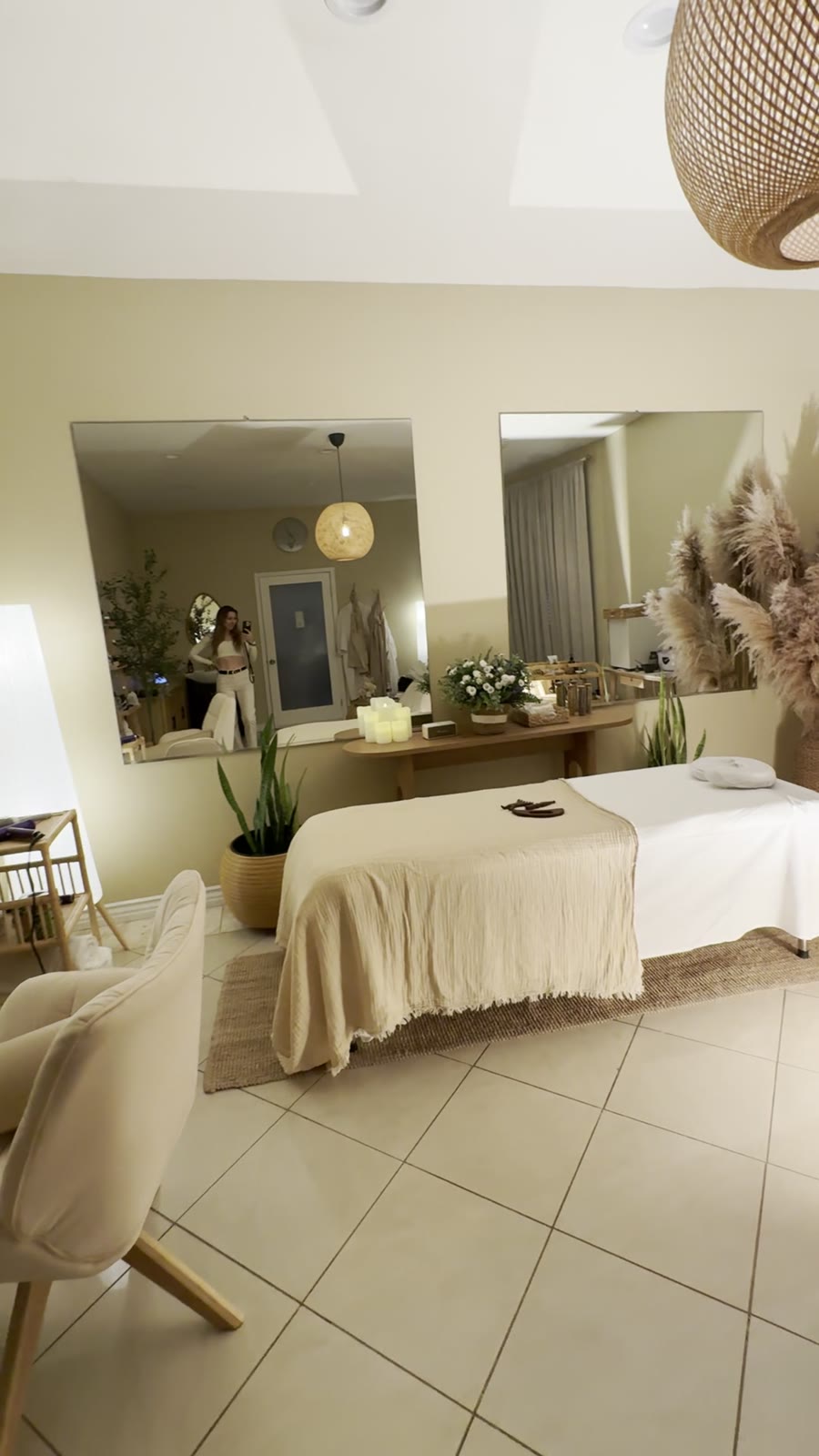 Inner You Head Spa treatment room with a draped massage table, mirrors, and warm boutique lighting.