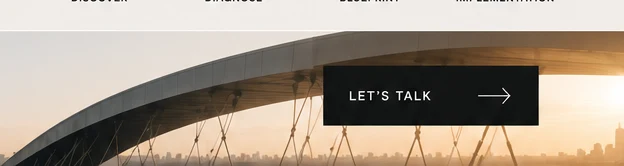 Architectural bridge curving above a warm city skyline.
