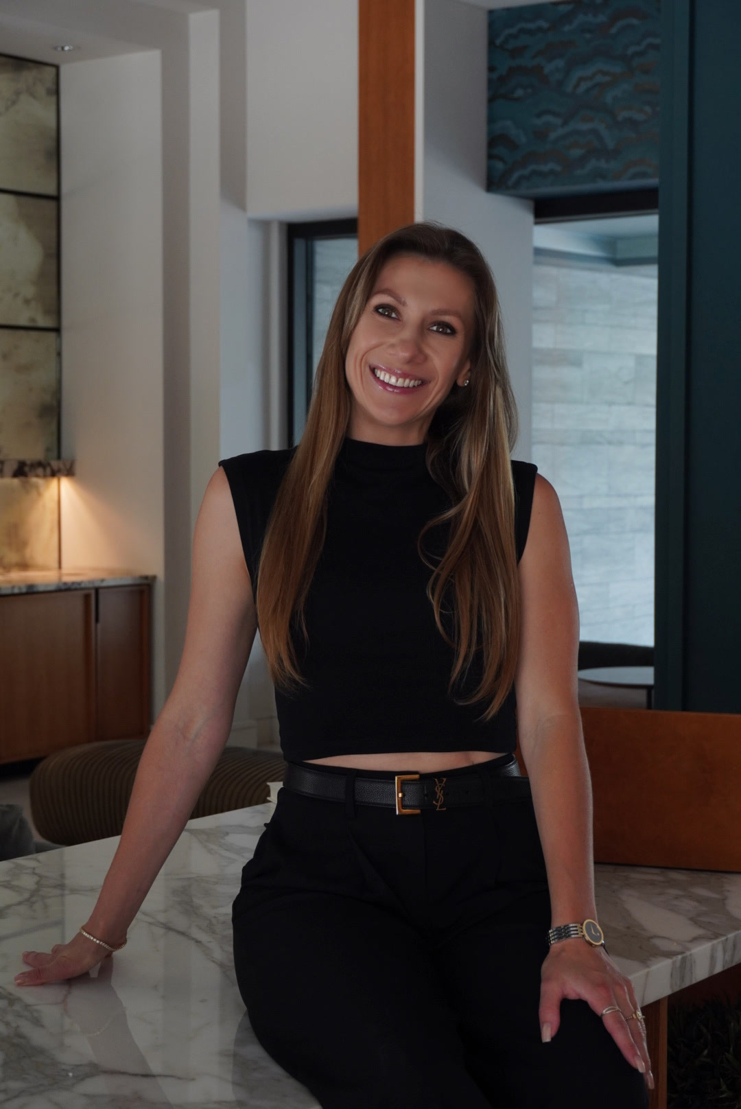 Viktoryia smiling beside a marble counter.