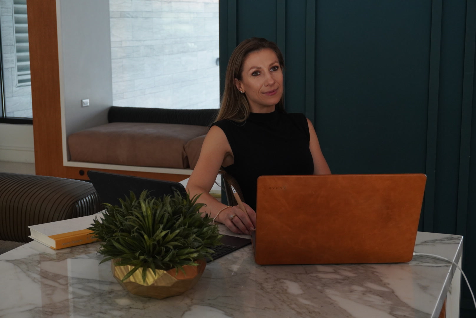 Viktoryia working through a business strategy at a marble table.